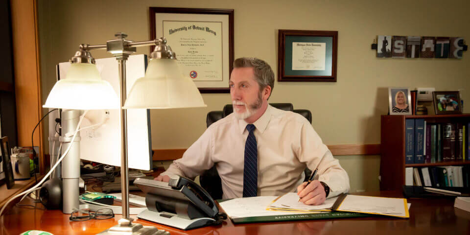 Michigan attorney Pat Richards working on a personal injury case at his desk